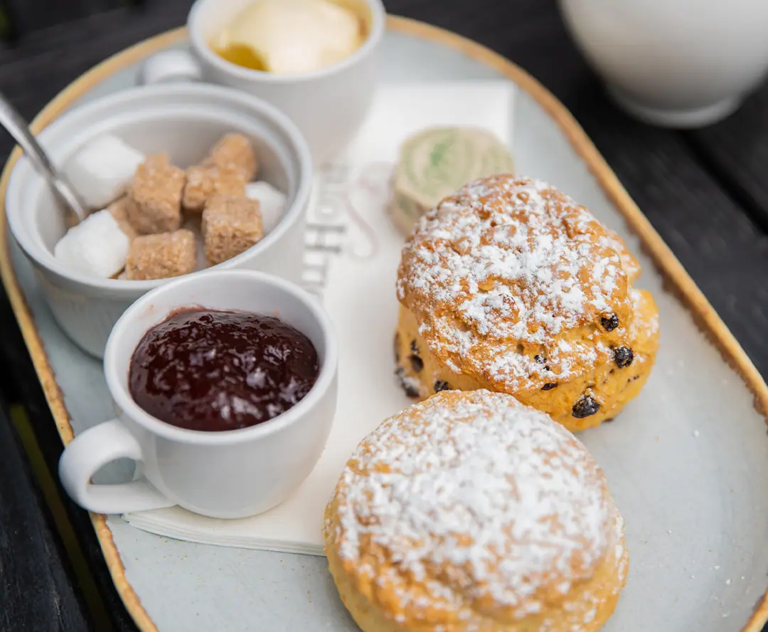Scones and jam on a serving plate