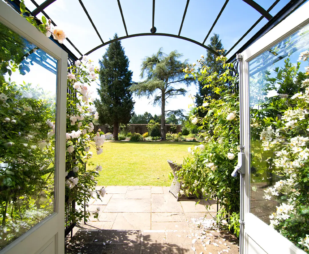 Doors open onto a garden arch