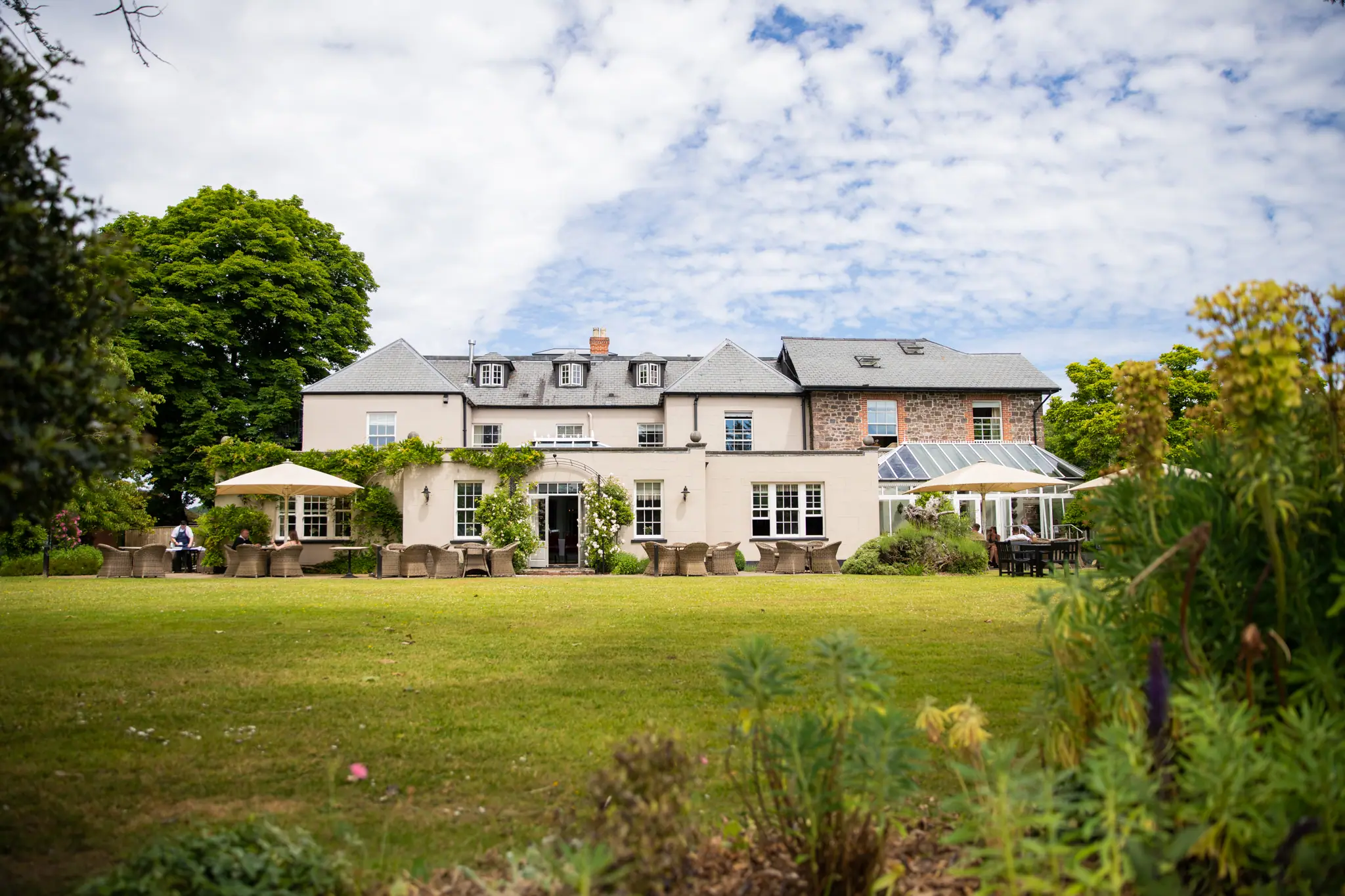 The Hartnoll Hotel across the lawn, with parasols on the terrace