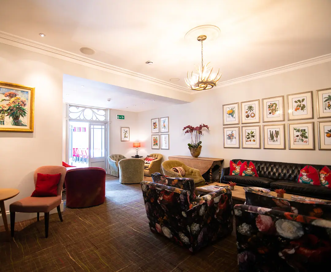 A sitting room hung with botanical prints
