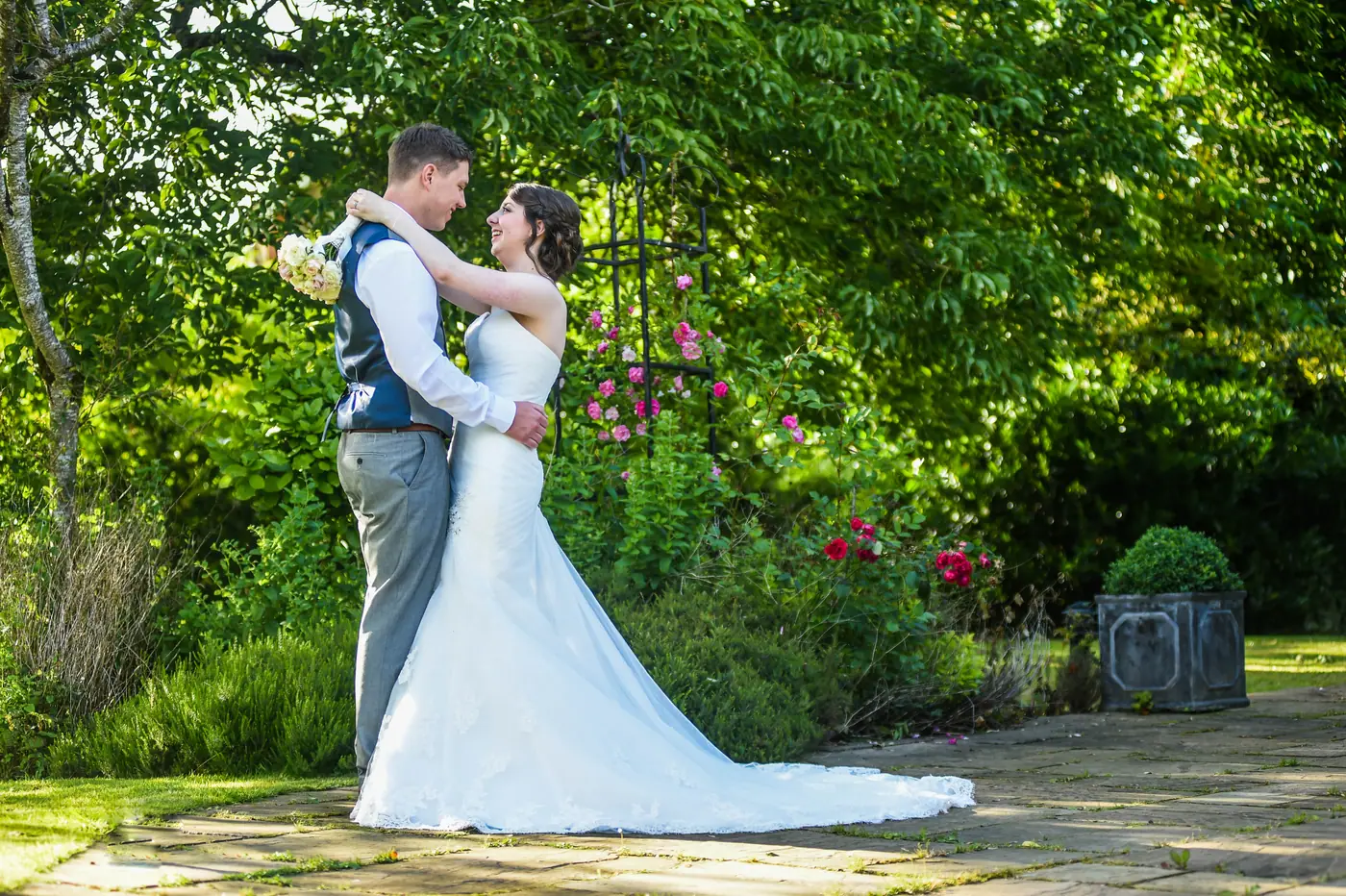 A couple beneath a rose arch